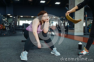 Tired overweight woman with trainer in sport club Stock Photo