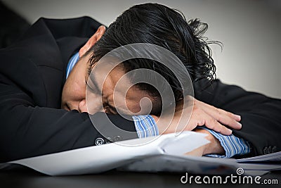 Tired overworked businessman sleeps Stock Photo