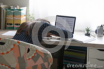 Tired overworked millennial woman freelancer daydreaming napping at home office. Stock Photo