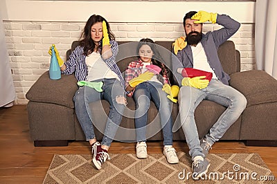 Tired parents and kid. Cleaning all day exhausting occupation. Exhausting cleaning day. Family mom dad and daughter with Stock Photo