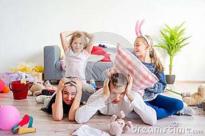 Tired parents and romping kids Stock Photo