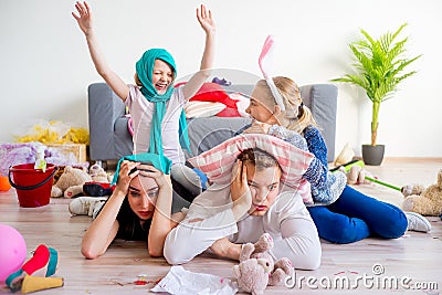 Tired parents and romping kids Stock Photo