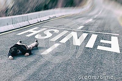 Tired powerless man in black jacket and grey trousers fallen on road overcome finish title Stock Photo