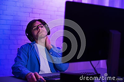 Tired Programmer Working On Computer Touching Aching Neck At Home Stock Photo