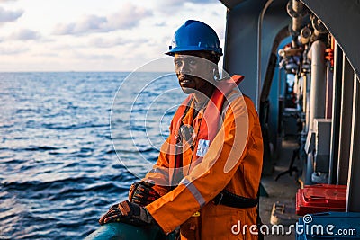 Seaman AB or Bosun on deck of vessel or ship , wearing PPE Stock Photo