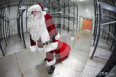 Tired Santa Claus loosing gifts from red sack Stock Photo