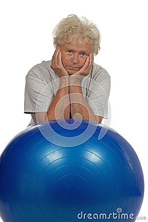 Tired senior woman with a fitball Stock Photo