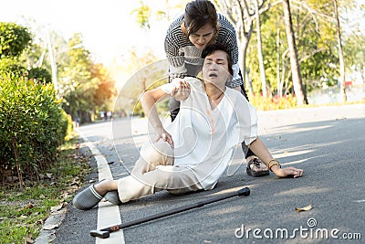 Tired senior woman or mother suffer from sunburn very hot,feeling faint,dizzy,daughter assisting,support her in outdoor at park, Stock Photo