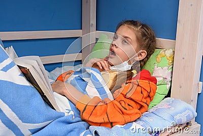 Tired sick girl prepares to once again sneeze lying in bed Stock Photo