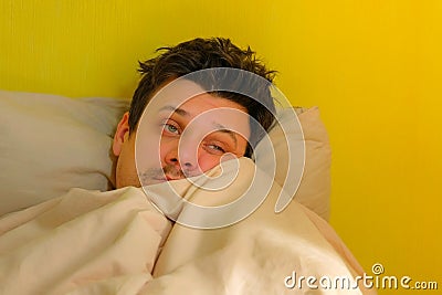 Tired sick man waking up with headache, depression, hangover, portrait closeup. Stock Photo