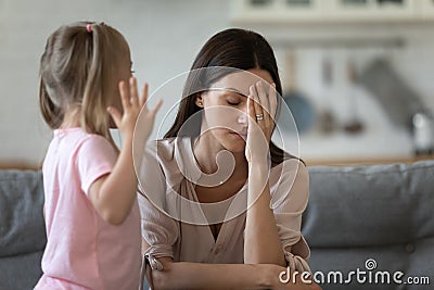 Tired single mother feel desperate about screaming kid daughter Stock Photo