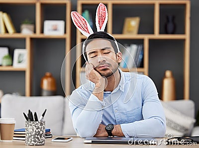 Tired, sleeping and a man for easter in an office with bunny ears for celebration or bored of a party. Stress, rabbit Stock Photo