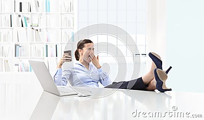 Tired sleepy business woman yawning, working at office desk and Stock Photo