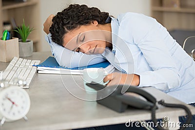 tired sleepy businesswoman resting on desk Stock Photo