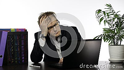 Tired sleepy disheveled businessman sitting at the table working hard in office Stock Photo