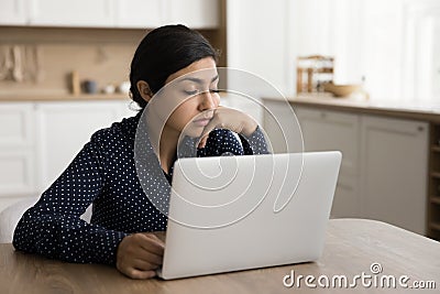 Tired sleepy Indian freelance woman sitting at home workplace table Stock Photo