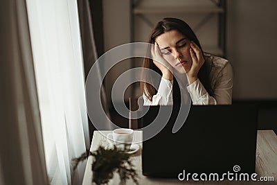 Tired sleepy woman overworking in her home office Stock Photo