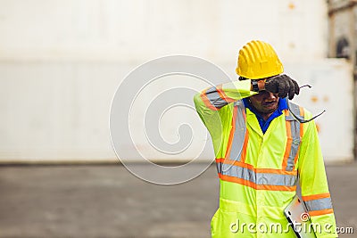 Tired stress worker sweat from hot weather in summer working in port goods cargo shipping logistic ground, Black African race Stock Photo