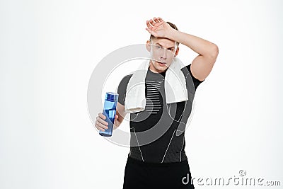 Tired strong sportsman drinking water Stock Photo