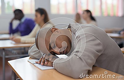 Tired student fell asleep in lesson in university classroom Stock Photo