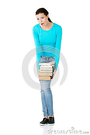 Tired student woman holding heavy books Stock Photo