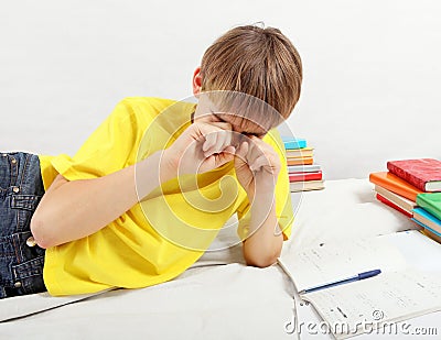 Tired Teenager doing Homework Stock Photo