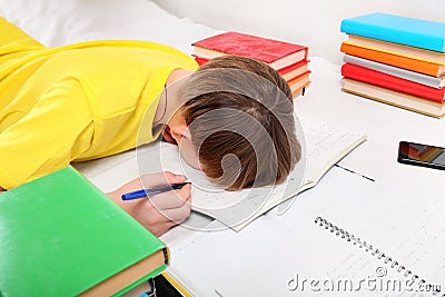 Tired Teenager doing Homework Stock Photo