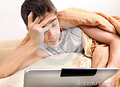 Tired Teenager with Tablet Computer Stock Photo