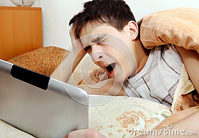 Tired Teenager with Tablet Computer Stock Photo