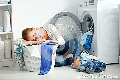 Tired unhappy woman housewife is engaged in the laundry, Stock Photo