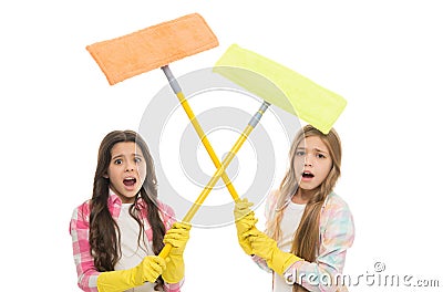 Tired of using a mop. Emotional little mop cleaners. Angry children crossing sticks with microfiber mop heads. Adorable Stock Photo
