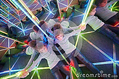 Tired of wandering girl lies on floor in mirror maze Stock Photo