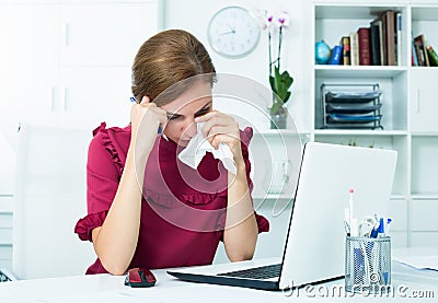 Tired woman crying at work Stock Photo