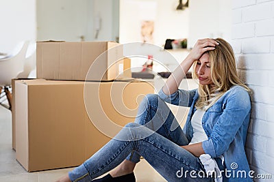 Tired woman exhausted while moving into new home Stock Photo