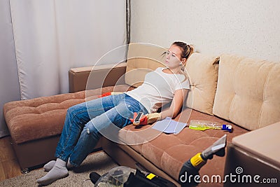 Tired woman having rest after cleaning home, lying on sofa in the living-room, copy space. Housekeeping and home Stock Photo