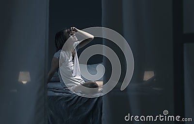 Tired sleepless woman suffering from the heat in bed Stock Photo