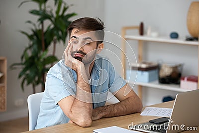 Tired worker wasting time at workplace distracted from boring job Stock Photo