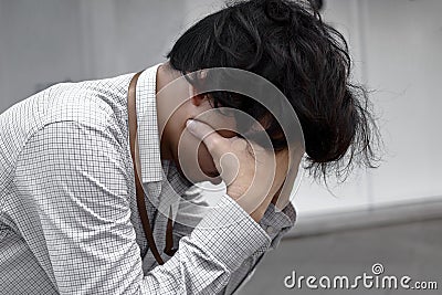 Tired and worried young Asian man in depression crying. Unemployment concept Stock Photo
