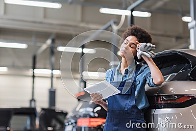 tired young african american mechanic with Stock Photo