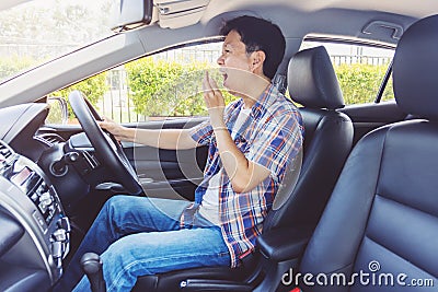 Tired young asia man driving his car Stock Photo