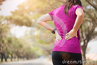 Tired Young asian Sport girl feel pain on her back and hip while exercising, health care concept Stock Photo