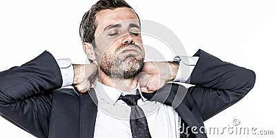 Tired young bearded businessman relaxing his tensed neck from exhaustion Stock Photo