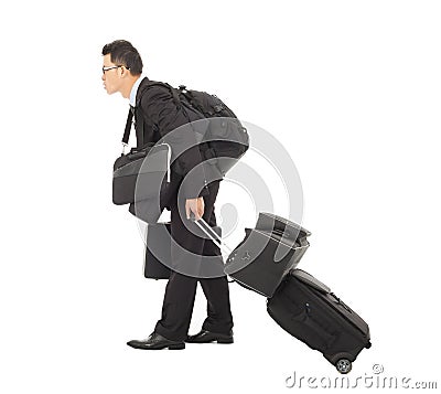 Tired young businessman pulling and belongings Stock Photo