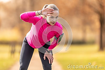 Tired young female athlete just after finishing the marathon Stock Photo