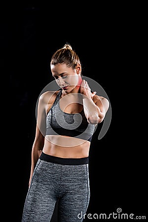 tired young sportswoman suffering from pain in neck Stock Photo