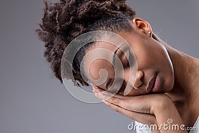 Tired young woman dozing with head on hands Stock Photo