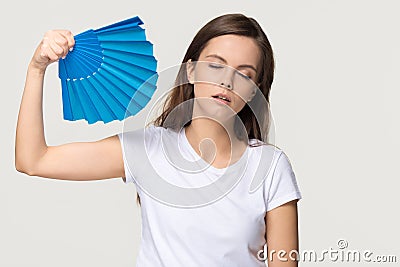 Tired young woman feel overheated suffering from heat waving fan Stock Photo