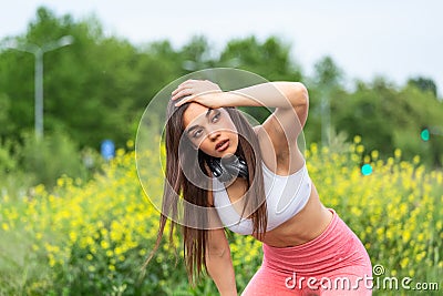 Tired young woman resting after jogging outdoor. Determined girl sweating and taking a rest after running hard. Exhausted curvy Stock Photo