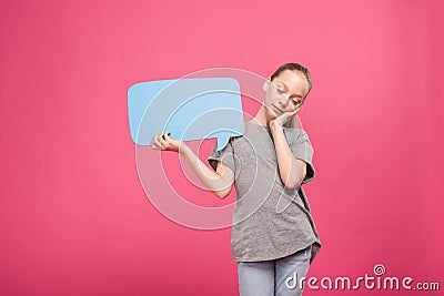 tired youngster relaxing and holding blue speech bubble, isolated Stock Photo