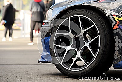 Tires of race car for driving. Drag and drift car with lower-profile tire. Racing low profile tyre with brake disc. Alloy wheel Stock Photo